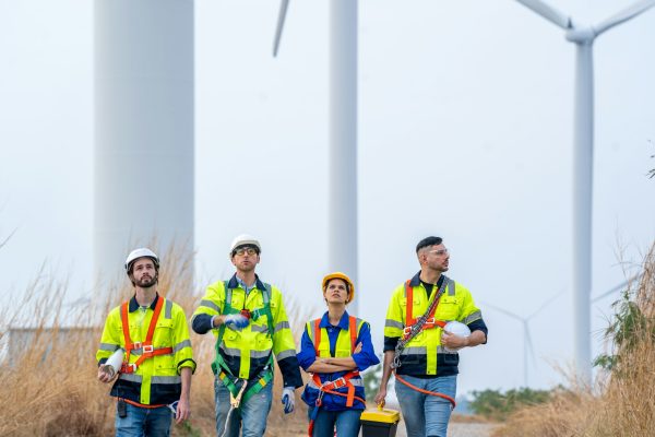Electrical engineer checking on wind turbine energy production. Electrical engineer checking on wind turbine energy production.
